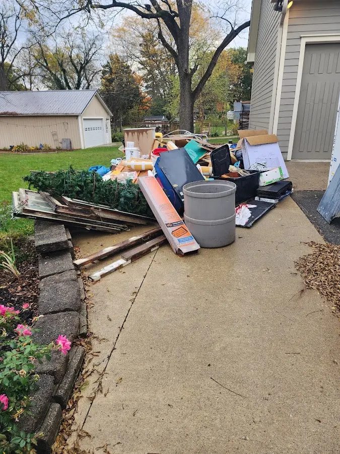 Dumpster being loaded with debris for 10 Yard Dumpster Rental in Independence